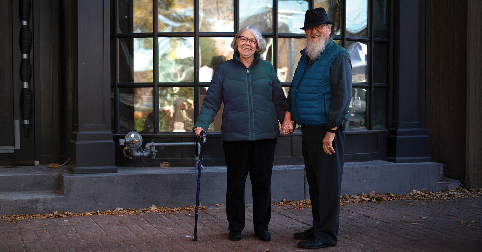 WEB-1920X1005_AdaptiveEquip a senior woman with a cane with her spouse outside on a Fall day