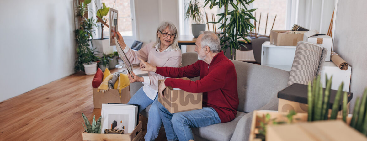 2 older adults sorting through boxes of belongings