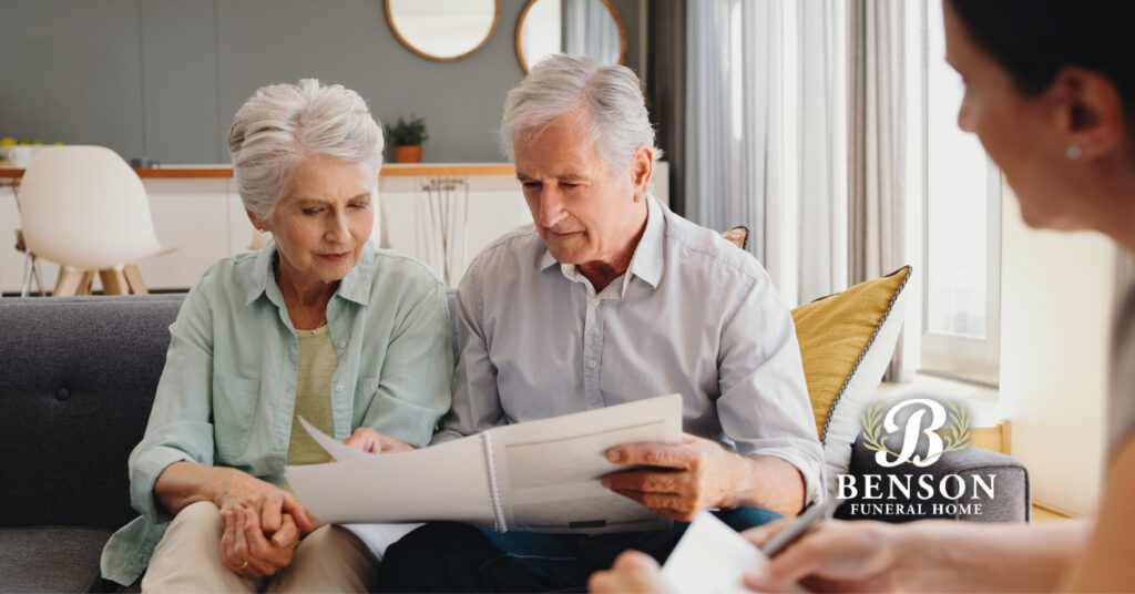 Two older adults reviewing options with a funeral director for end-of-life celebrations (includes the Benson Funeral Home logo)