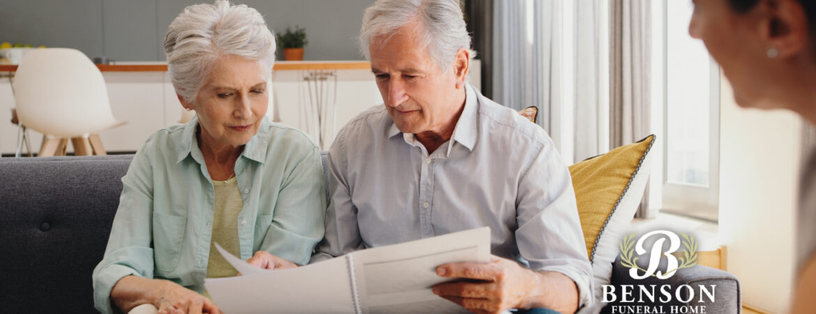 Two older adults reviewing options with a funeral director for end-of-life celebrations (includes the Benson Funeral Home logo)