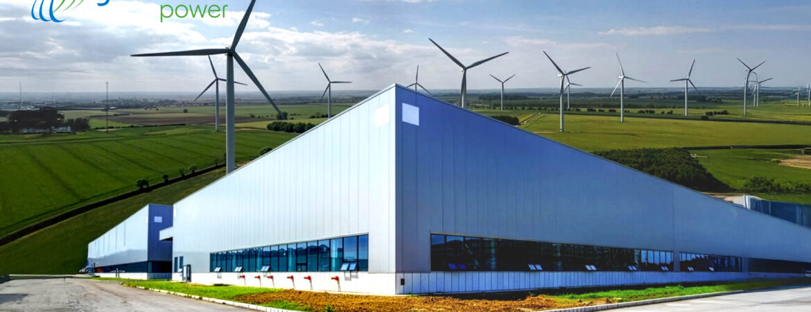 Industrial building with sleek glass facade in a rural landscape. Wind turbines dot the distant fields under a partly cloudy sky. "Geronimo Power" logo in top left.